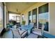 Cozy screened patio with an outdoor seating area and a view through large sliding glass doors to a water view at 5222 Granite Dust Pl, Palmetto, FL 34221