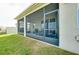 View of the screened-in patio from the backyard with outdoor furniture at 5222 Granite Dust Pl, Palmetto, FL 34221