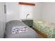 Bedroom featuring two twin beds, a nightstand, and a bright window view at 542 Walnut Cir, Venice, FL 34285
