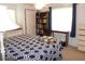 Cozy bedroom with blue and white patterned quilt, closet, and bright window at 542 Walnut Cir, Venice, FL 34285
