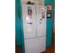 Functional kitchen features a white refrigerator and bright colored walls with enough space at 542 Walnut Cir, Venice, FL 34285
