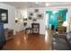 Inviting living room with wood floors, adjacent kitchen, and bright teal painted room at 542 Walnut Cir, Venice, FL 34285