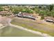 Aerial view of a townhome community with lakefront property and screened lanais at 5559 Brassy Loop, North Port, FL 34287