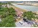 Aerial view of townhomes showing the lake view, mature trees, and convenient parking at 5559 Brassy Loop # 5559, North Port, FL 34287