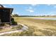 Backyard view showcasing green grass and scenic views of the adjacent lake at 5559 Brassy Loop, North Port, FL 34287