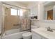 Well-maintained bathroom features a tub and shower, vanity with sink, and storage cabinet at 5559 Brassy Loop # 5559, North Port, FL 34287