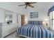 Bright bedroom with a ceiling fan, plenty of natural light, and ample closet space at 5559 Brassy Loop, North Port, FL 34287