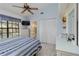 Comfortable bedroom with en suite bathroom, ceiling fan, and ample closet space at 5559 Brassy Loop, North Port, FL 34287