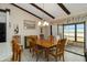 Charming dining area with wood table, chairs, and a view of the screened-in patio at 5559 Brassy Loop, North Port, FL 34287