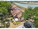 View of townhomes near the water, beautiful landscaping, and exterior features that blend harmoniously with nature at 5559 Brassy Loop, North Port, FL 34287