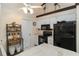 Efficient kitchen with white cabinets and black appliances at 5559 Brassy Loop, North Port, FL 34287