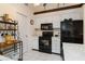 Efficient kitchen with white cabinets and black appliances at 5559 Brassy Loop # 5559, North Port, FL 34287