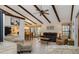 Spacious living room with vaulted ceilings, exposed beams and abundant natural light at 5559 Brassy Loop, North Port, FL 34287