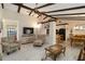 Bright living room featuring vaulted ceilings with wooden beams, tile floors, and comfortable seating at 5559 Brassy Loop, North Port, FL 34287