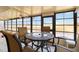 Relaxing sunroom with panoramic windows offering serene views of the surrounding area at 5559 Brassy Loop, North Port, FL 34287