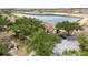 Aerial view of townhouses near a lake and green spaces at 5559 Brassy Loop, North Port, FL 34287