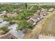 Aerial view of townhouses with tree coverage, green spaces, and parking areas at 5559 Brassy Loop, North Port, FL 34287