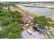Beautiful aerial view of townhouse with parking, mature landscaping, and serene lake views at 5559 Brassy Loop, North Port, FL 34287