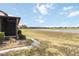 A serene backyard view features a lush lawn extending to a peaceful pond, perfect for relaxation and enjoying nature at 5559 Brassy Loop, North Port, FL 34287