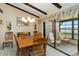 Dining area with beamed ceilings connecting to an enclosed sunroom overlooking the water at 5559 Brassy Loop, North Port, FL 34287