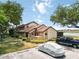 Townhouse exterior showcasing covered porch, parking, and landscaping at 5559 Brassy Loop, North Port, FL 34287