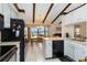 Cozy kitchen open to dining area, featuring ample counter space and white cabinetry at 5559 Brassy Loop, North Port, FL 34287