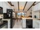 Cozy kitchen open to dining area, featuring ample counter space and white cabinetry at 5559 Brassy Loop, North Port, FL 34287