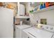 Efficient laundry room featuring modern appliances, storage cabinets and shelves for organization at 5559 Brassy Loop, North Port, FL 34287