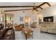 Bright living room with beamed ceilings and a view of the bedroom and front door at 5559 Brassy Loop, North Port, FL 34287