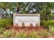 Fairway Villas community sign surrounded by lush landscaping offers a welcoming entrance and enhances curb appeal at 5559 Brassy Loop, North Port, FL 34287