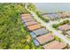 Stunning aerial view of homes with private pools nestled in a beautiful lakeside community at 5581 Piccolo St, Nokomis, FL 34275