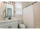 This bright bathroom offers a white vanity, quartz countertop, modern lighting, and a tiled shower and tub at 5581 Piccolo St, Nokomis, FL 34275