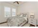 This bedroom features a decorative bed, side tables with lamps, plantation shutters, and luxury vinyl floors at 5581 Piccolo St, Nokomis, FL 34275