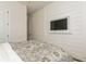 This bedroom showcases vinyl plank walls, a television, and a comfortable decorative bed at 5581 Piccolo St, Nokomis, FL 34275
