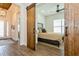 Cozy bedroom featuring a sliding barn door entry, plantation shutters, and serene decor at 5581 Piccolo St, Nokomis, FL 34275