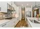 View of the kitchen with modern white cabinets and stainless steel appliances at 5581 Piccolo St, Nokomis, FL 34275