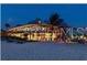 Captivating night view of a beachfront restaurant illuminated against the dark sky at 5581 Piccolo St, Nokomis, FL 34275