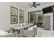 Outdoor dining area with comfortable seating, ceiling fan and a view of the living room at 5581 Piccolo St, Nokomis, FL 34275
