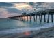 Stunning sunset view of the pier stretching into the ocean, creating a tranquil and picturesque scene at 5581 Piccolo St, Nokomis, FL 34275