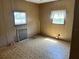Bedroom featuring two windows over carpeted floor at 5668 Holiday Park Blvd, North Port, FL 34287