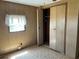 A bedroom featuring a window and closet with open doors, over carpeted floor at 5668 Holiday Park Blvd, North Port, FL 34287