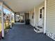 Spacious carport with access to a screened-in porch and entrance to the single story house at 5668 Holiday Park Blvd, North Port, FL 34287