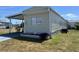 One-story home featuring covered parking, a well-maintained lawn, and a charming garden bed at 5668 Holiday Park Blvd, North Port, FL 34287