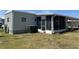 Single-story house features a screened-in porch and neat lawn at 5668 Holiday Park Blvd, North Port, FL 34287