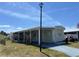 Inviting single-story home with a covered parking area and manicured landscaping at 5668 Holiday Park Blvd, North Port, FL 34287