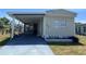 Charming single-story home featuring a covered carport and well-maintained lawn at 5668 Holiday Park Blvd, North Port, FL 34287