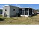 Single-story house features a screened-in porch and neat lawn at 5668 Holiday Park Blvd, North Port, FL 34287