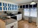A kitchen featuring custom-painted cabinetry, an electric range, and a window with a butterfly-themed valance at 5668 Holiday Park Blvd, North Port, FL 34287