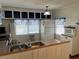 A kitchen showcasing white cabinetry and appliances, a stainless-steel trashcan, and a kitchen sink with divider at 5668 Holiday Park Blvd, North Port, FL 34287