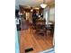 Inviting dining area with a glass top table, wooden chairs, and an elegant chandelier, adjacent to the kitchen at 603 Leisure, Venice, FL 34285